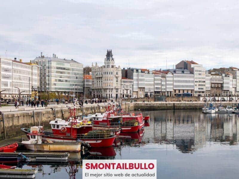 A harbor filled with lots of boats next to tall buildings