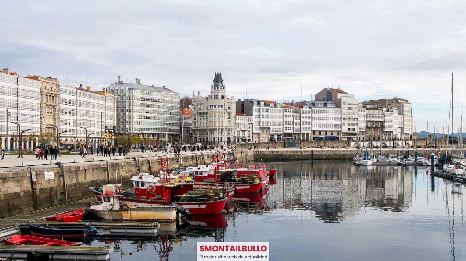 A harbor filled with lots of boats next to tall buildings