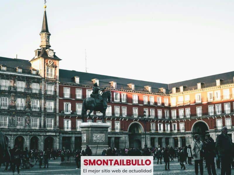 A lively scene at Plaza Mayor, Madrid, featuring historic architecture and a statue.